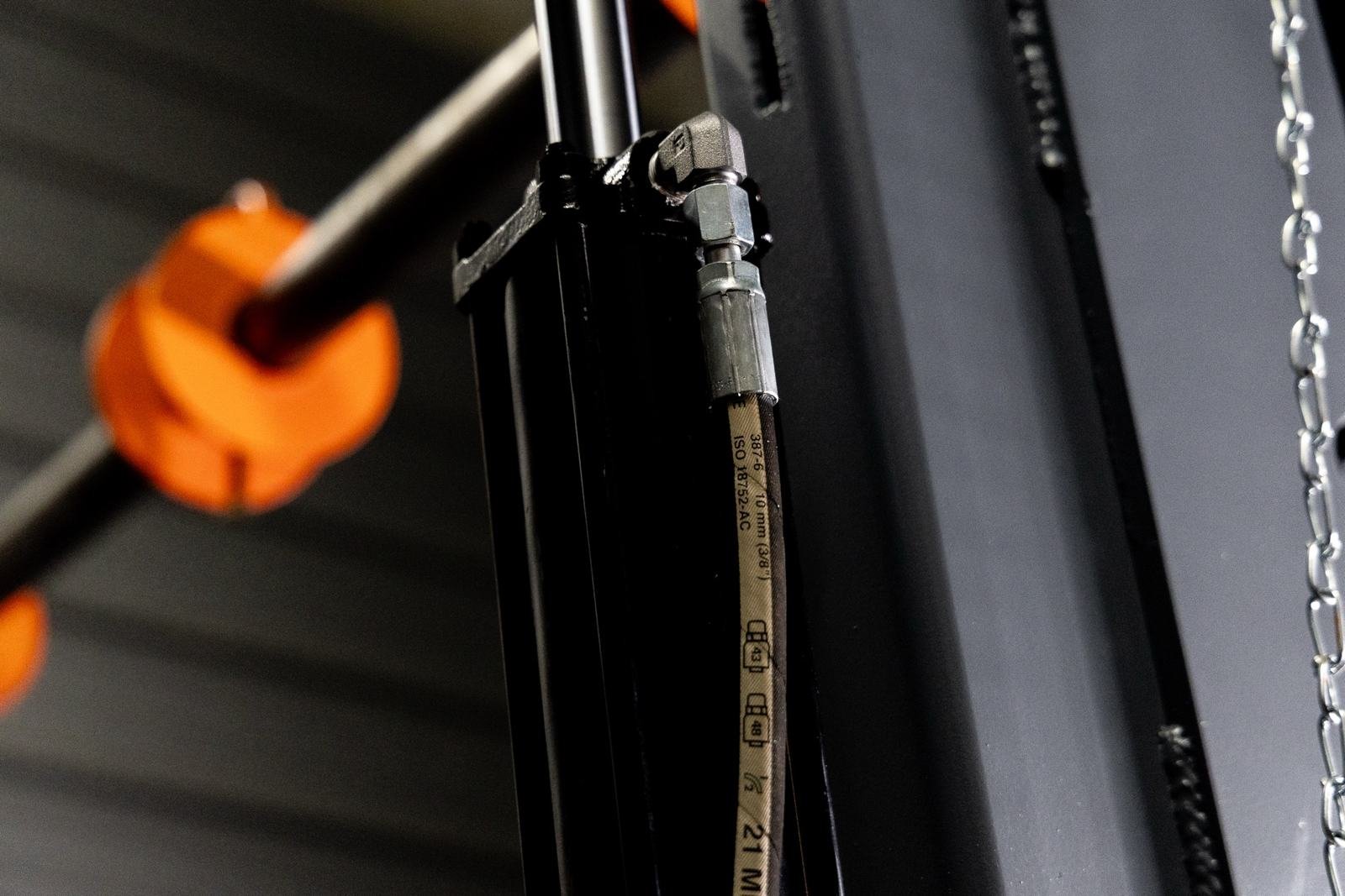 Hydraulic hose routing along the frame of a cable reel trailer