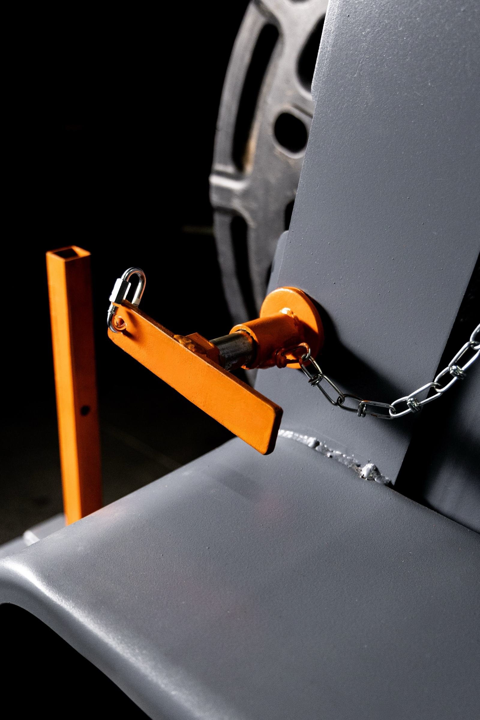 Reel bar lock and safety chain detail on a cable reel trailer